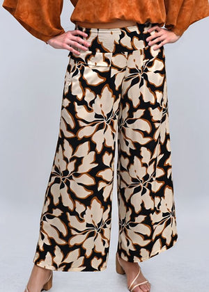 Floral patterned pants worn by a person on a light gray background